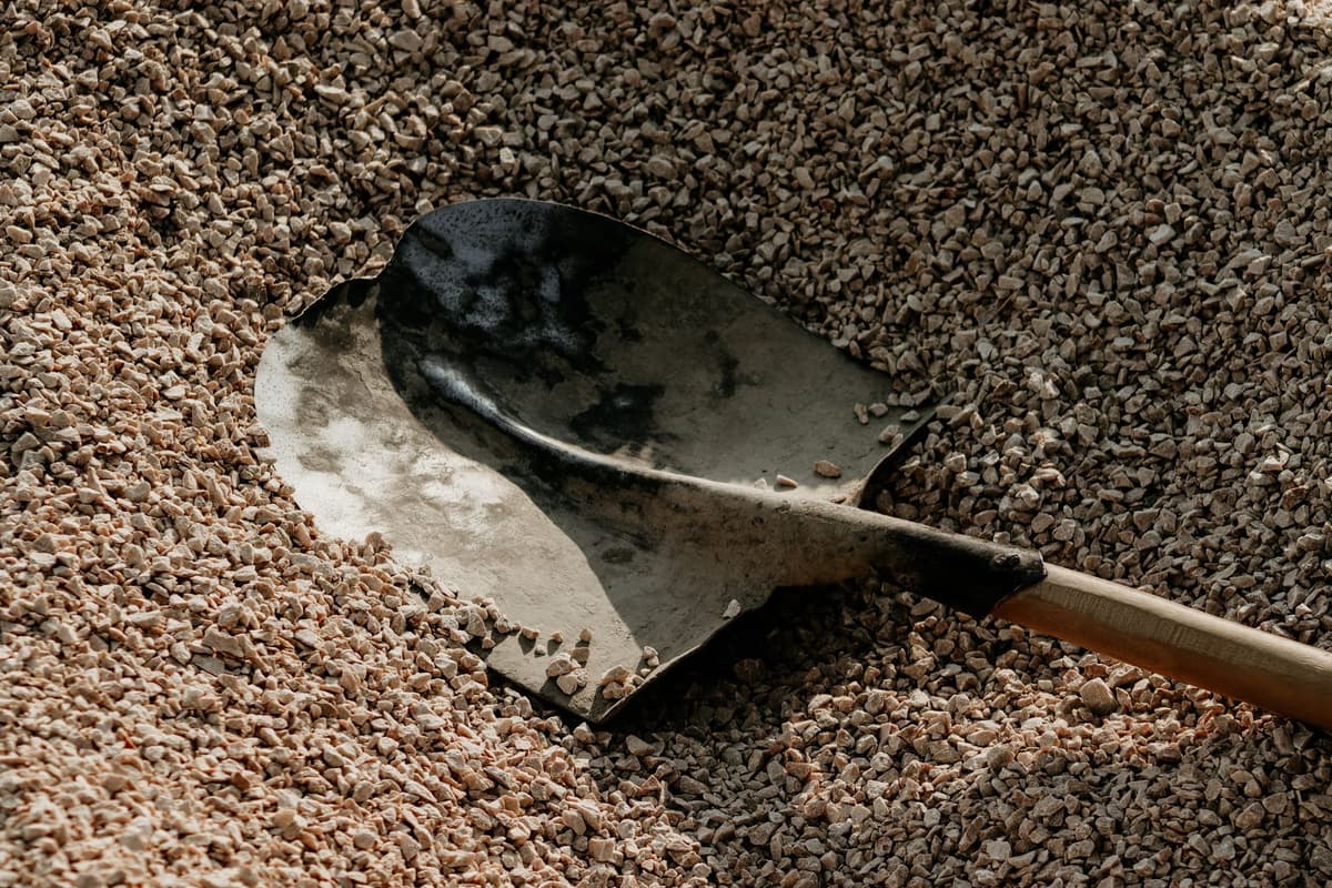 vintage gold mining pan filled with crushed gravel