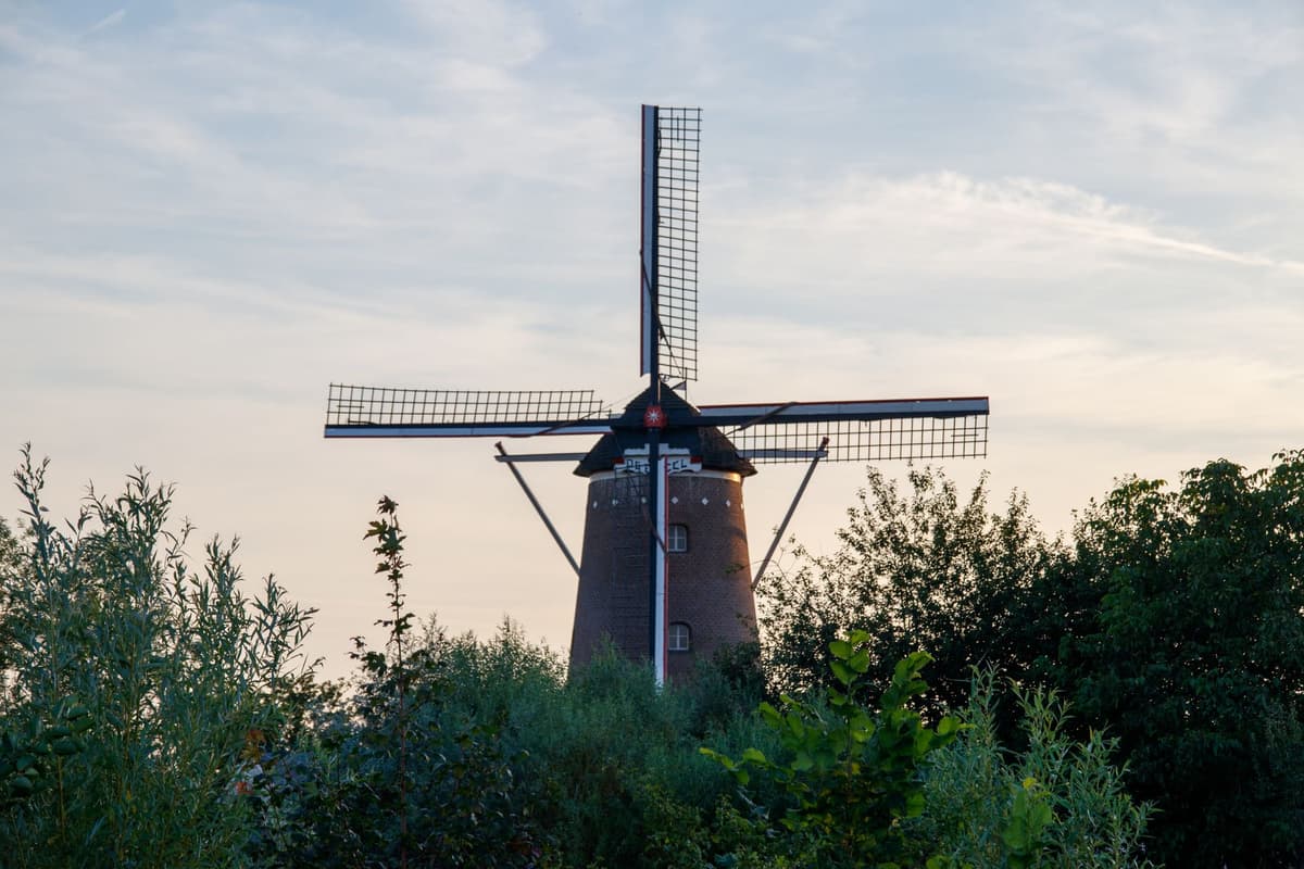a Dutch windmill with a glowing green circuit board pattern instead of sails