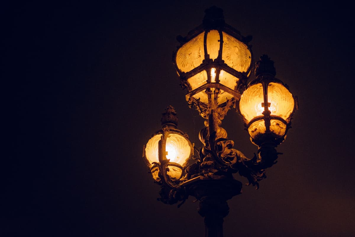 a single glowing streetlamp over a dark field