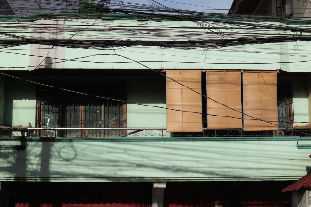 a tangled nest of black electrical wires overhead