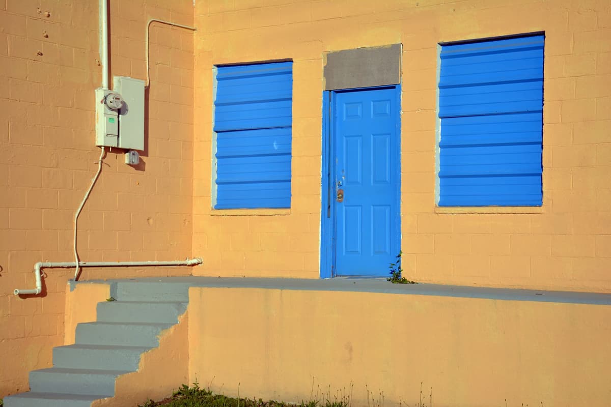a bright yellow digital electricity meter on a wall