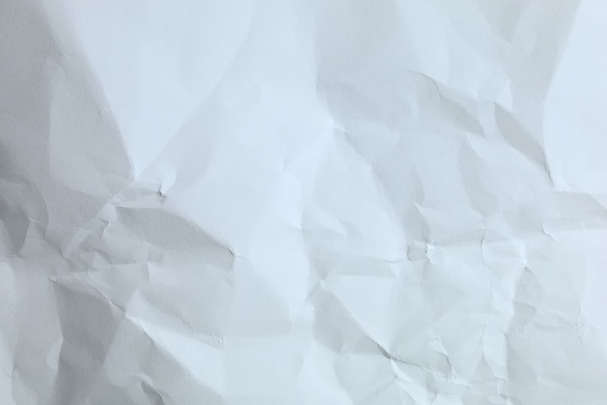 a single sheet of white paper folded into a complex geometric maze