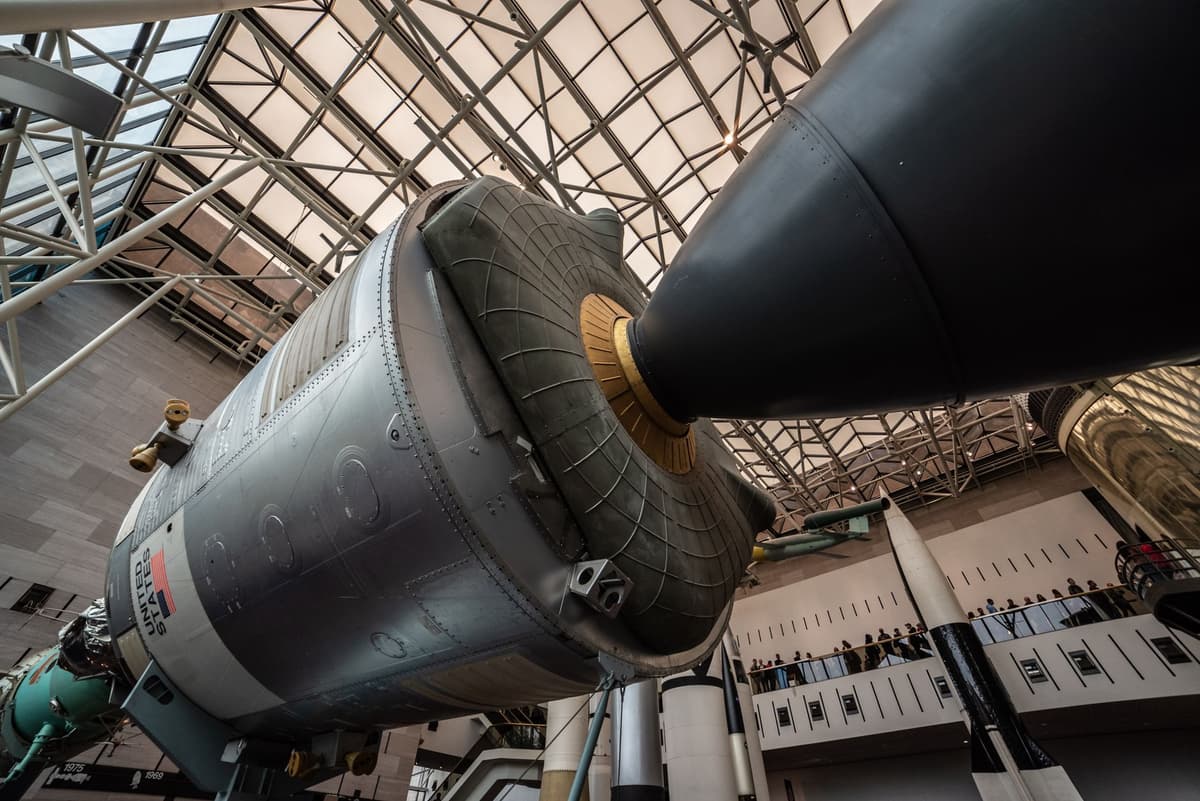 a dusty blue rocket engine on a test stand