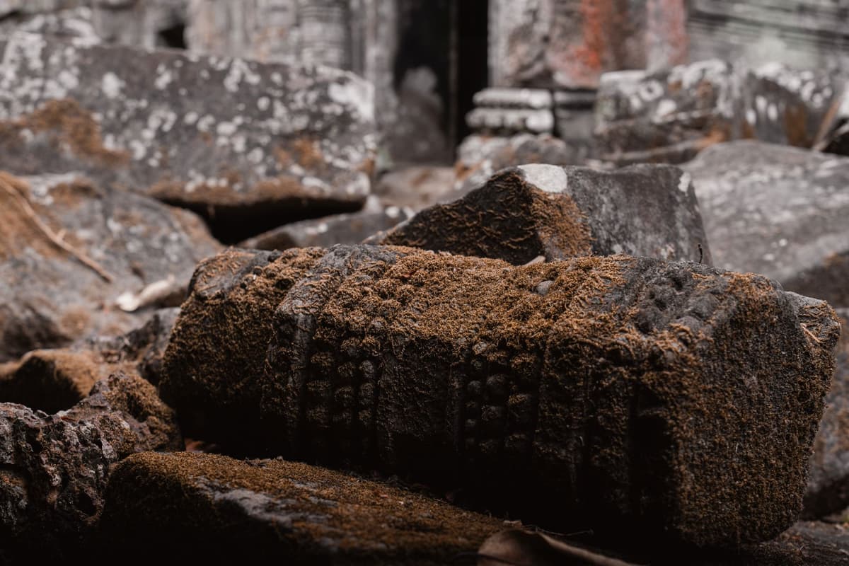 scorched stone ruins of an ancient temple foundation