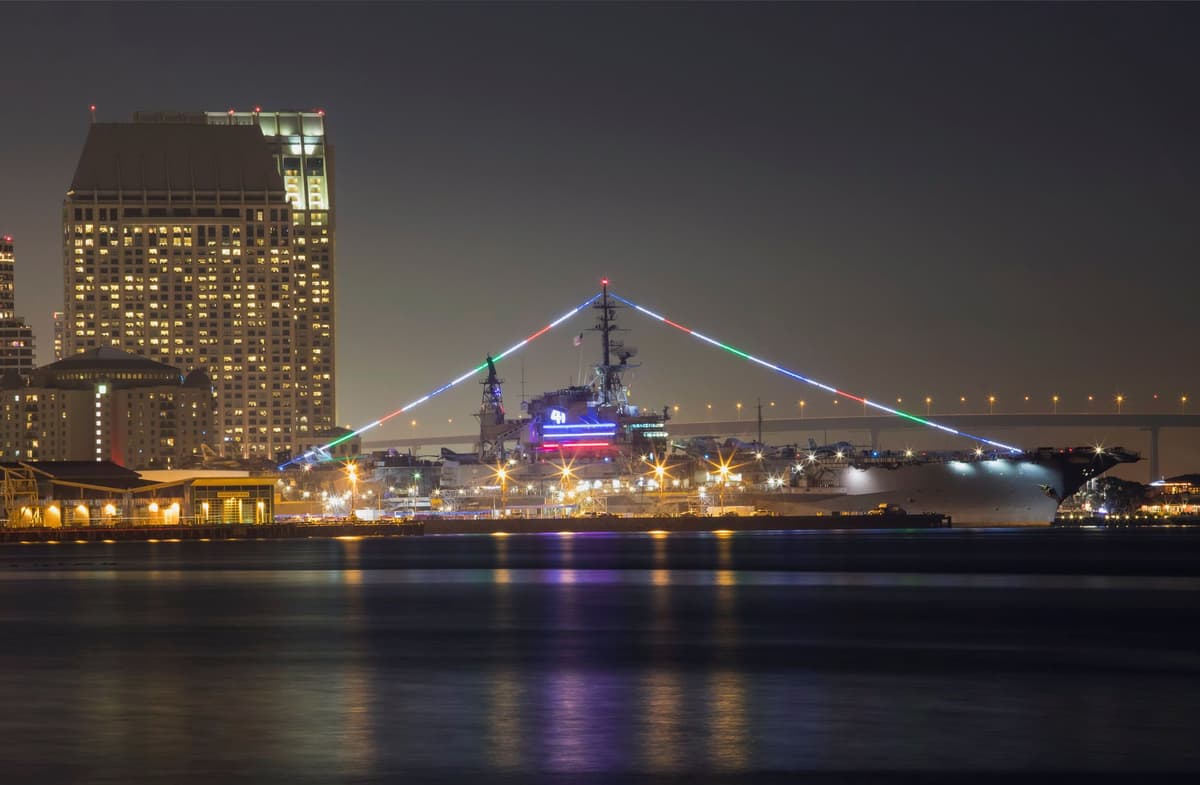 a massive gray aircraft carrier deck at dusk