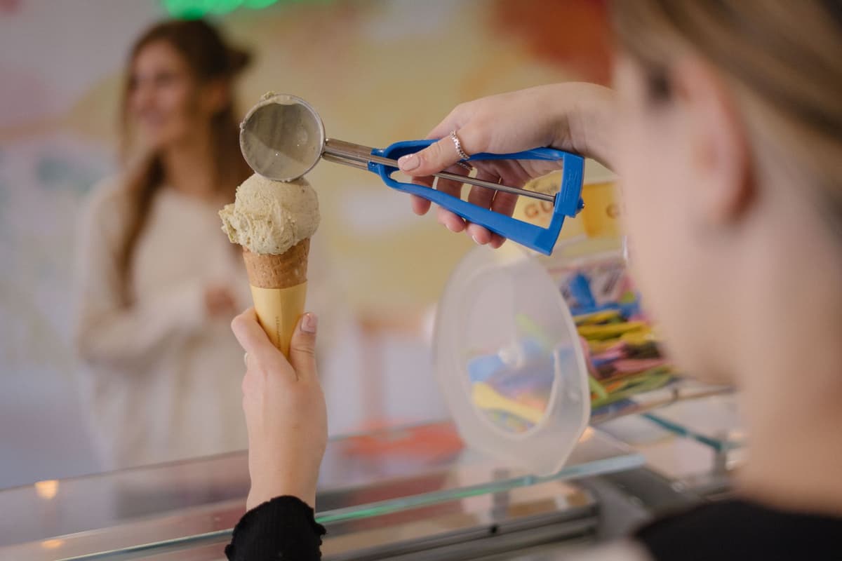a frantic developer holding a melting ice cream cone over a server
