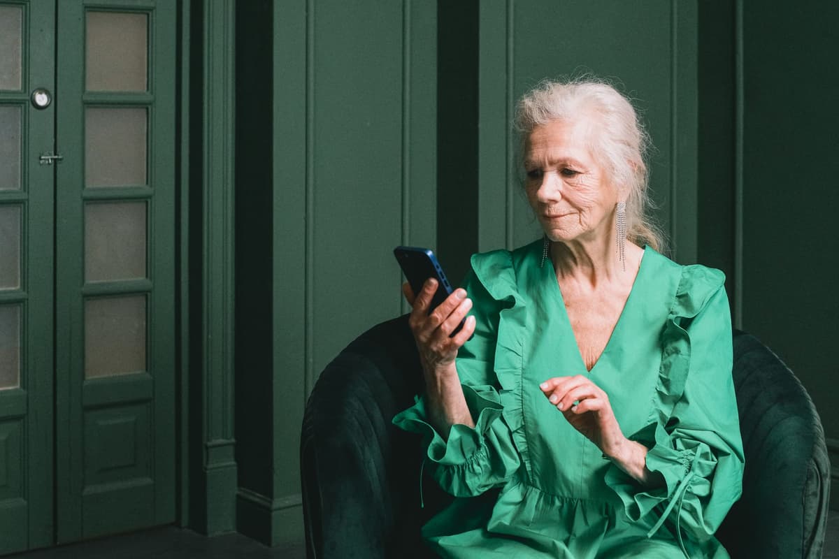 elderly person looking confused at a smartphone