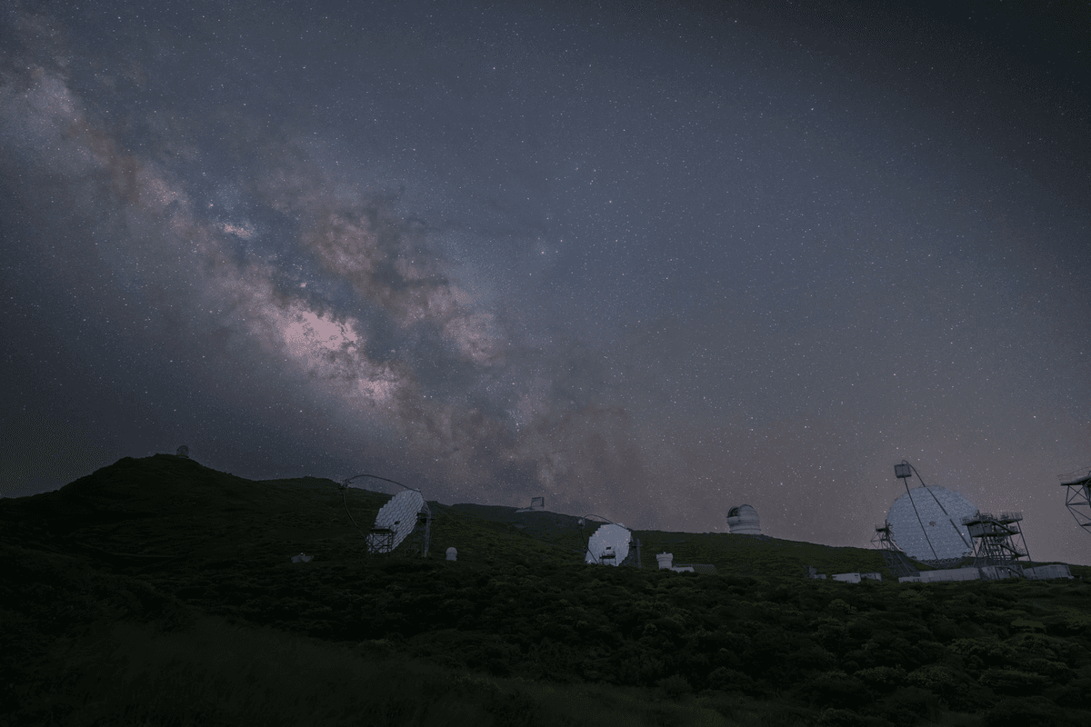 a high-tech telescope lens reflecting a dark starry sky