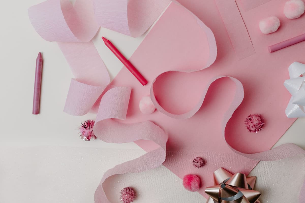 a vintage hatchet tied with a pink silk bow