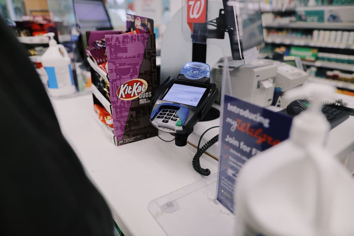 a glowing supermarket checkout scanner displaying a red X over a milk carton