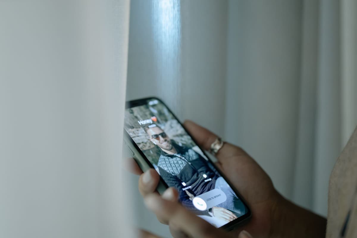 a ring light reflecting in a smartphone screen