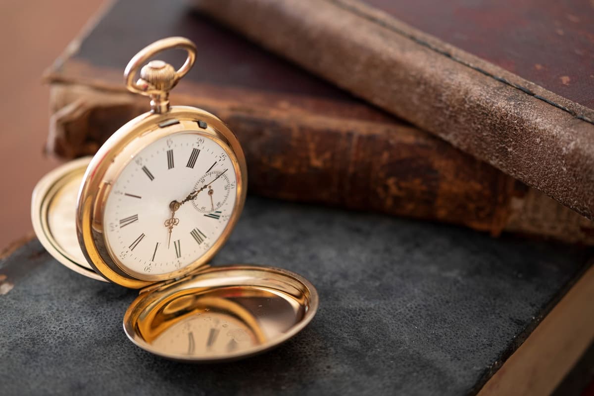 antique pocket watch next to a medical stethoscope