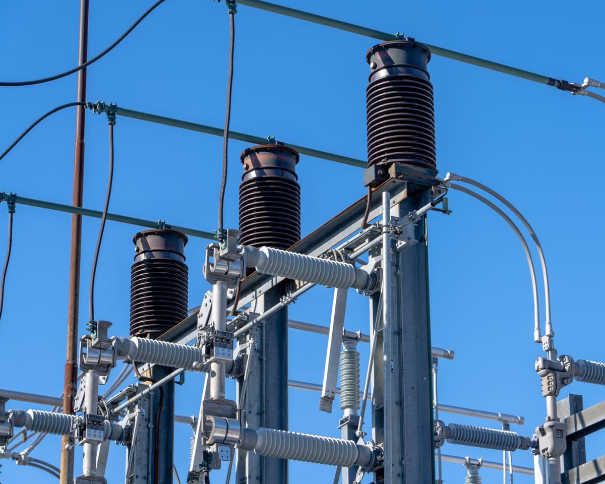 industrial high-voltage electrical substation under cloudy sky