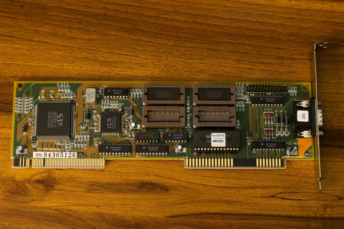 a dusty computer graphics card on a wooden table